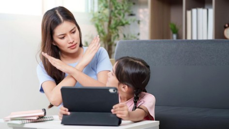 Child using a tablet at home.